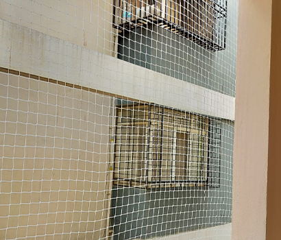 Balcony safety nets installed in a home apartment in Bangalore for balcony safety and bird protection.
