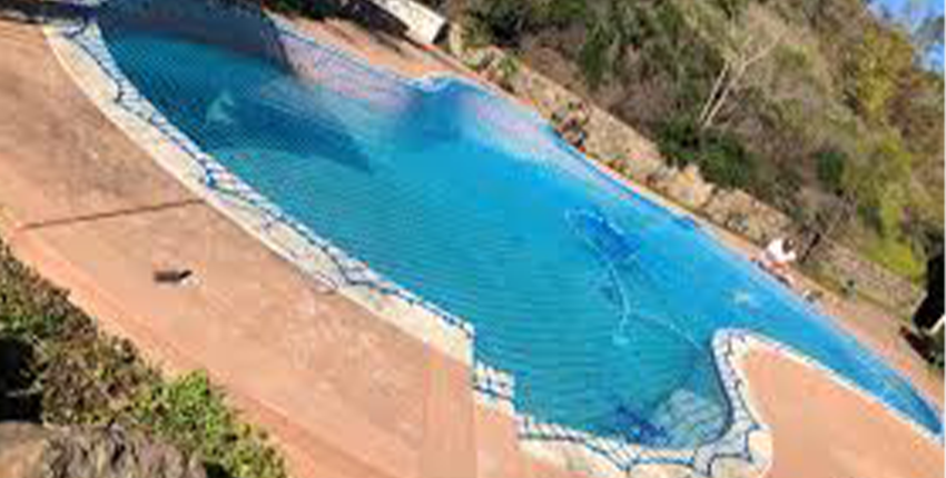 Swimming pool covered with safety nets in Bangalore for child protection and safety.

